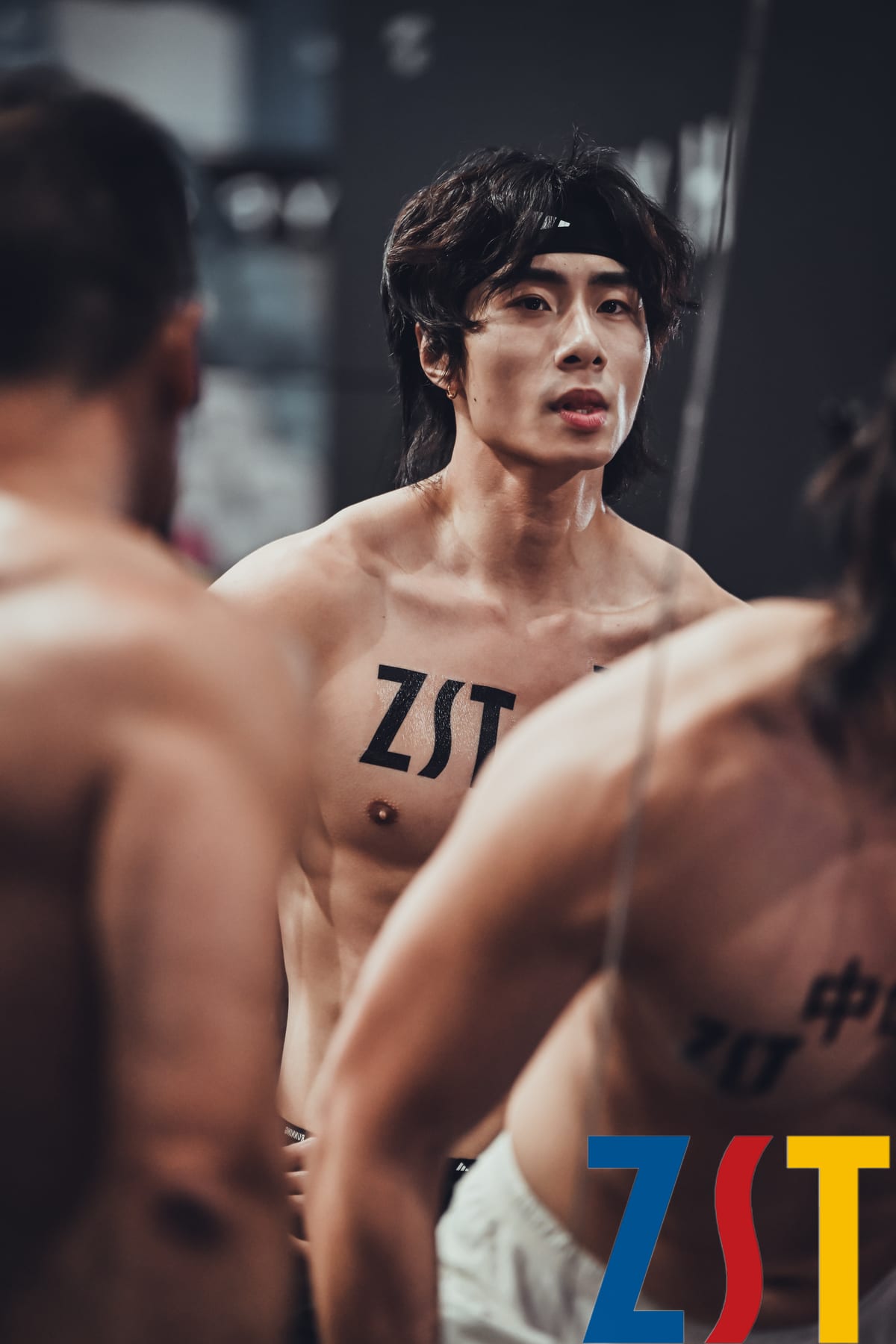 Close-up of a ZST water-transfer tattoo on an athlete at HYROX Beijing